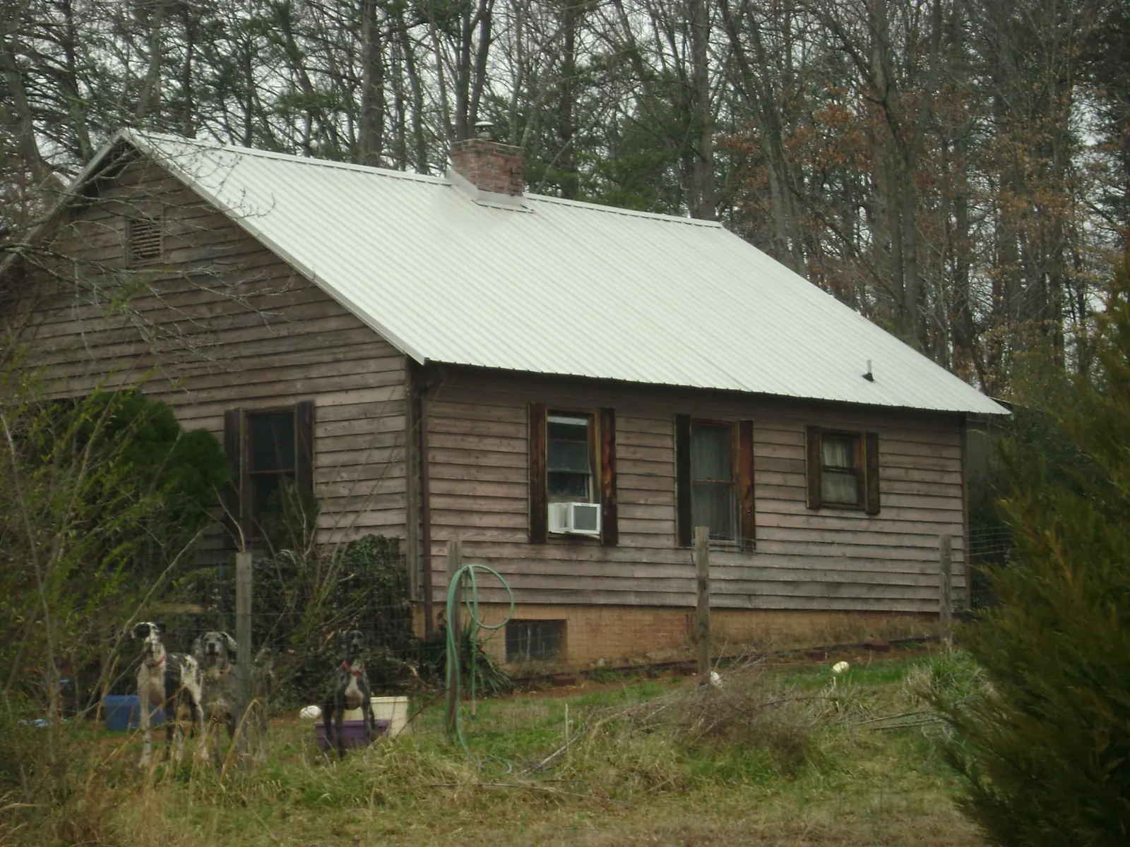 White metal roof on an old wood sided farmhouse, from a Metal Roof Installation job in Beechgrove